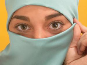 Muslim woman's eyes peering through a traditional hajib