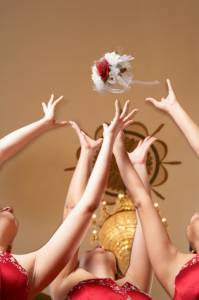 European wedding tradition involving bridesmaids reaching for bouquet