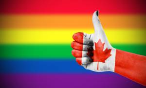 Canadian thumbs up in front of gay marriage flag