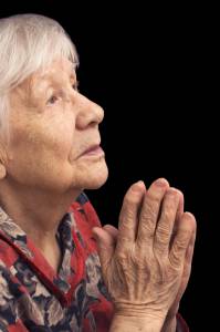 The old woman prays on a black