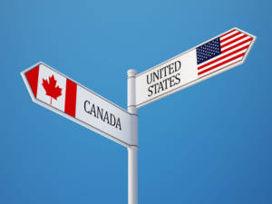 sign pointing to canada and united states